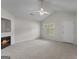 Spacious living room with a fireplace, neutral carpet, ceiling fan, and ample natural light at 120 Bramble Bush Trl, Covington, GA 30014
