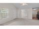 Inviting living room featuring neutral carpet, ample natural light, and access to the kitchen at 120 Bramble Bush Trl, Covington, GA 30014