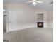 Bright living room featuring neutral carpet, a fireplace, and a view into other rooms at 120 Bramble Bush Trl, Covington, GA 30014