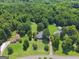 Expansive aerial view of lush green property with multiple residences and bordering forest at 1120 Rawlings Dr, Rutledge, GA 30663