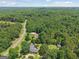 Aerial view showcasing a property nestled among dense, green trees, offering serene privacy at 1120 Rawlings Dr, Rutledge, GA 30663