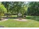 Expansive backyard features a fire pit area, lush lawn, and mature trees at 1120 Rawlings Dr, Rutledge, GA 30663