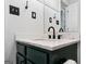 Bathroom vanity featuring marble countertop, bronze faucet, and white wainscoting at 1120 Rawlings Dr, Rutledge, GA 30663