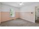 Bedroom with natural lighting, neutral carpeting, wainscoting and view to a doorway at 1120 Rawlings Dr, Rutledge, GA 30663