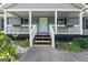 Charming front porch with hanging baskets and freshly landscaped garden at 1120 Rawlings Dr, Rutledge, GA 30663