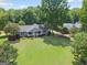 Charming home featuring a well-manicured front lawn, welcoming porch, and mature shade trees at 1120 Rawlings Dr, Rutledge, GA 30663