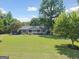 Home featuring a well-manicured front lawn, welcoming porch, and mature shade trees at 1120 Rawlings Dr, Rutledge, GA 30663