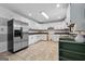 Updated kitchen with stainless steel appliances, tile flooring, and ample countertop space at 1120 Rawlings Dr, Rutledge, GA 30663