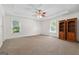 Spacious main bedroom features carpet floors, a trey ceiling with fan, and two windows at 1120 Rawlings Dr, Rutledge, GA 30663