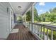 Inviting covered front porch featuring a swing and classic wood railing at 1120 Rawlings Dr, Rutledge, GA 30663