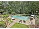 Aerial view of backyard oasis with pool, lush landscaping, and ample seating for relaxing outdoors at 140 Silvermere, Fayetteville, GA 30215