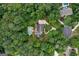 Aerial view of the property showcasing the pool, lush landscaping, and surrounding trees at 140 Silvermere, Fayetteville, GA 30215