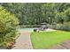 Relaxing backyard featuring a pool, lounge chairs, and meticulously maintained landscaping at 140 Silvermere, Fayetteville, GA 30215
