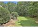 Lush, well-maintained backyard with stone pathway and manicured landscaping at 140 Silvermere, Fayetteville, GA 30215
