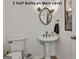 Half-bathroom with pedestal sink, decorative mirror and lighting, and bronze fixtures at 140 Silvermere, Fayetteville, GA 30215
