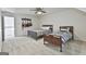 Spacious bedroom featuring two beds, a ceiling fan, and wall-mounted guitars for a unique touch at 140 Silvermere, Fayetteville, GA 30215