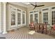 Covered outdoor deck with ceiling fan, offering a relaxing space for entertaining or enjoying the outdoors at 140 Silvermere, Fayetteville, GA 30215