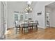 Bright dining area with skylight, hardwood floors, a stylish chandelier, and access to the outdoor patio at 140 Silvermere, Fayetteville, GA 30215