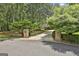 Long, winding driveway leading to the home, flanked by manicured landscaping and mature trees at 140 Silvermere, Fayetteville, GA 30215