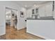 Bright entryway featuring hardwood floors, staircase, and a built-in bar with white cabinets and dark countertops at 140 Silvermere, Fayetteville, GA 30215