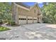 Spacious three-car garage with a large driveway and mature trees providing shade at 140 Silvermere, Fayetteville, GA 30215