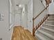 Well-lit hallway with stairway, neutral walls, and hardwood floors leading to various rooms within the home at 140 Silvermere, Fayetteville, GA 30215