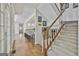 Hallway leads to the kitchen and stairway showcasing hardwood floors and natural light, enhancing the home's charm at 140 Silvermere, Fayetteville, GA 30215