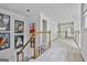 Upstairs hallway with carpet, decorative artwork, and railing at 140 Silvermere, Fayetteville, GA 30215