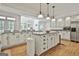 Bright, airy kitchen with white cabinetry, granite countertops, an island, and views to the breakfast nook at 140 Silvermere, Fayetteville, GA 30215