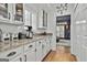 Bright kitchen with white cabinets, granite countertops, stainless appliances, and a view into the elegant living room at 140 Silvermere, Fayetteville, GA 30215
