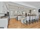 Spacious kitchen with granite countertops, stainless appliances, white cabinetry, island seating, and hardwood floors at 140 Silvermere, Fayetteville, GA 30215