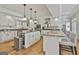 Open kitchen with granite countertops, stainless steel appliances, white cabinets, and spacious island seating at 140 Silvermere, Fayetteville, GA 30215