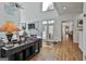 Open living room with high ceilings, large windows, fireplace, and access to a patio with double doors at 140 Silvermere, Fayetteville, GA 30215