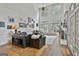 Bright living room features tall windows, hardwood floors, comfortable seating, and elegant decor at 140 Silvermere, Fayetteville, GA 30215