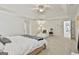 Serene main bedroom features a tray ceiling, chair, and access to the en-suite bathroom at 140 Silvermere, Fayetteville, GA 30215