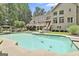 Spacious backyard with an in-ground pool, diving board, and lush landscaping at 140 Silvermere, Fayetteville, GA 30215