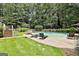 Refreshing swimming pool surrounded by lush greenery, lounge chairs, and a tranquil backyard setting at 140 Silvermere, Fayetteville, GA 30215