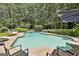 Inviting backyard pool with a hammock and lounge chairs for relaxation at 140 Silvermere, Fayetteville, GA 30215