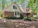 Back exterior of house showcasing deck and sunroom at 25 Ridgeview Dr, Jonesboro, GA 30236