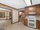 Traditional kitchen featuring wood cabinets, white appliances, and pass-through to living areas at 25 Ridgeview Dr, Jonesboro, GA 30236