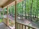 Inviting covered porch showcasing peaceful views of a verdant, tree-filled backyard at 25 Ridgeview Dr, Jonesboro, GA 30236