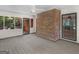 Bright sunroom features brick accent wall, ceiling fan and access to the backyard at 25 Ridgeview Dr, Jonesboro, GA 30236