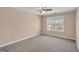 Cozy bedroom with a ceiling fan and a large window overlooking the yard at 362 Interlake Pass, Mcdonough, GA 30252