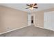 Bedroom features neutral carpet, ceiling fan and trim with bright white doors at 362 Interlake Pass, Mcdonough, GA 30252
