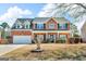 Charming two-story brick home with manicured lawn and attached two-car garage at 362 Interlake Pass, Mcdonough, GA 30252