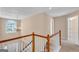 Foyer with staircase and chandelier lighting with natural light from window at 362 Interlake Pass, Mcdonough, GA 30252