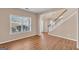 Open living room with hardwood floors, large windows, and staircase in view at 362 Interlake Pass, Mcdonough, GA 30252