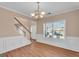 Open living space with hardwood flooring, decorative molding, and staircase at 362 Interlake Pass, Mcdonough, GA 30252