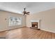 Bright living room with a fireplace, hardwood floors, and a ceiling fan at 362 Interlake Pass, Mcdonough, GA 30252