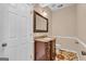 Stylish powder room with dark wood vanity, granite countertop, and decorative flooring at 362 Interlake Pass, Mcdonough, GA 30252